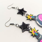 Sparkly Black Star Topped Skull Bomb Trapeze Earrings